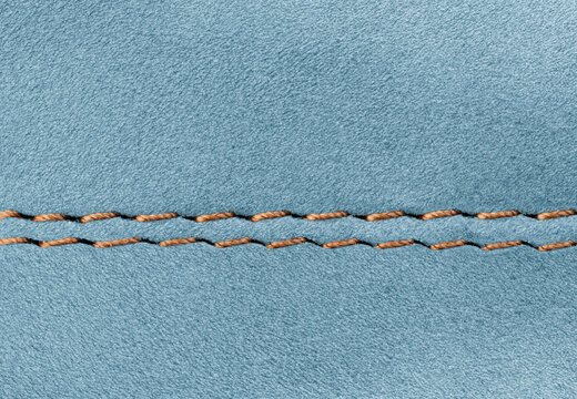 Close-up of Blue suede leather texture with double stitching