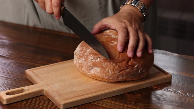 Slicing fresh cornbread into slices on a wooden board