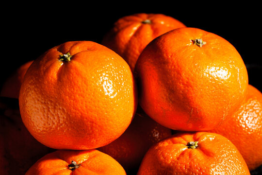 tangerine heap on black background