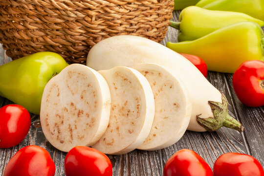 sliced white eggplant on wood background