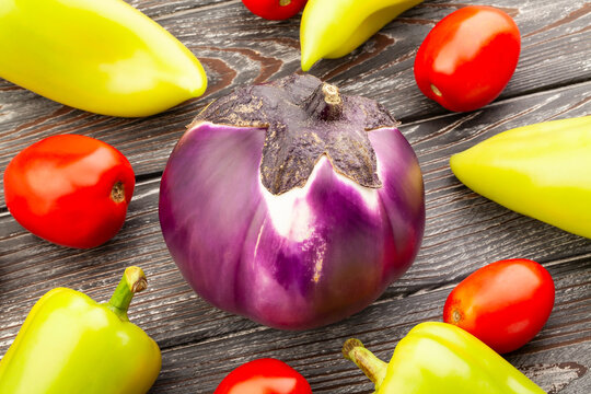 round purple eggplant on wood background
