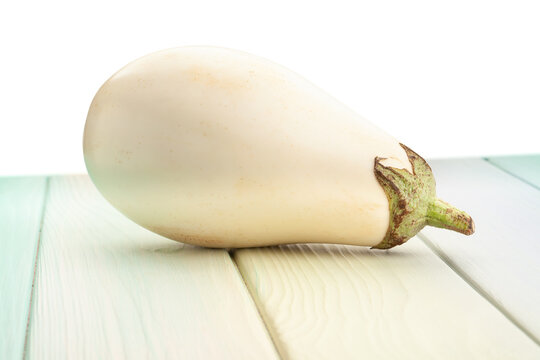 white eggplant on wood background on white