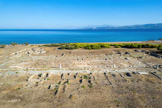 Aerial view of the Early Christian Basilica of Saint Leonidas at Lechaion, Corinthia, Greece, with excavated foundations and marble remains beside the blue Gulf of Corinth.