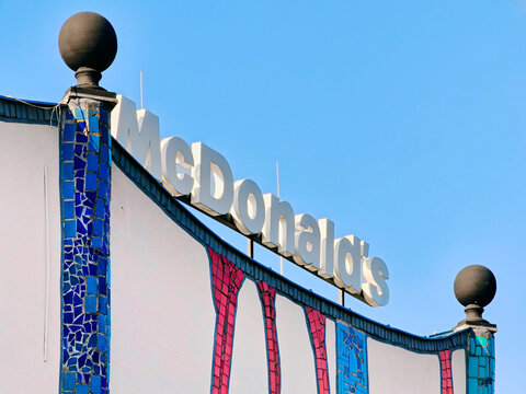 Unique McDonald's restaurant exterior with mosaic decoration in Austria built by the famous Austrian architect Friedensreich Hundertwasser - Wiener Neustadt, Austria - August 16, 2026