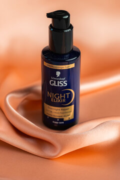 Schwarzkopf Gliss Night Elixir hair repair serum bottle on pink silk fabric background