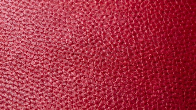 Close up of red leather texture with natural grain pattern