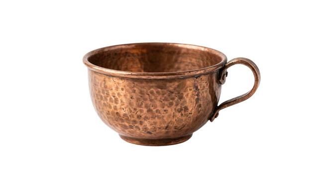 Vintage hammered copper cup with handle. Antique metal mug for rustic kitchen decor. Handcrafted copper vessel isolated on white background.