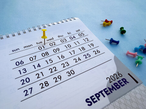 1st September 2026 desk calendar page with yellow push pin and colorful thumbtacks stock photo
