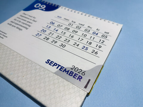 September month 2026 desk calendar page on blue paper background stock photo