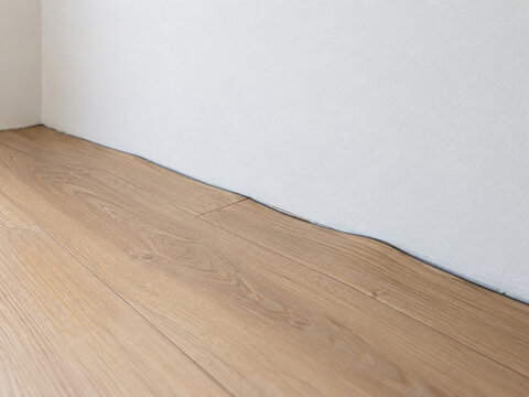 Buckled SPC Flooring at a Wall with Insufficient Expansion Gap