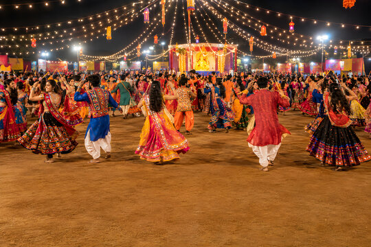 Group of People Dancing Garba in Traditional Outfits During Navratri Night Festival