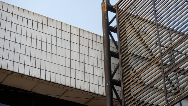 Diagonal metal louver panel installed on a commercial building exterior for sun protection and modern architectural style.