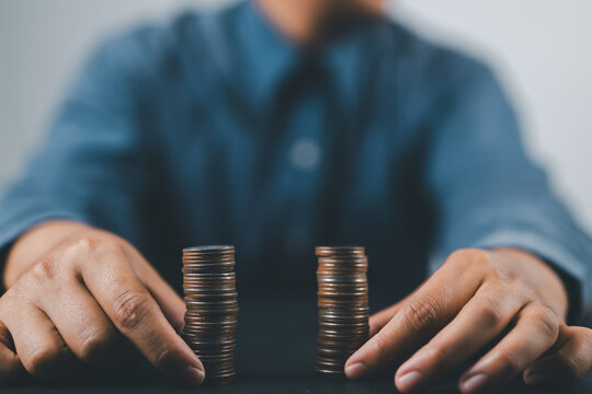 Businessman separates stack coins. Concept of  saving and investing.  Property division. Divorce and legal services.