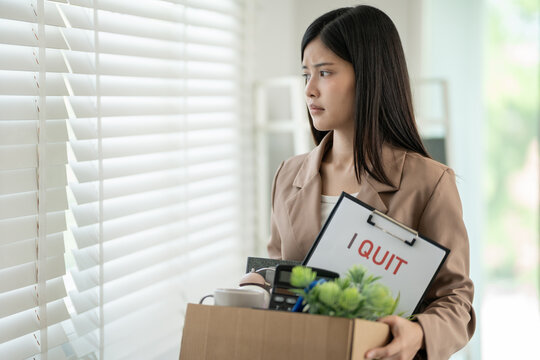 resignation, leave, quit, Stressful businesswomen will resign from the company. Female staff is lifting a brown paper box that holds personal items. , job placement and vacancies, resignation letter