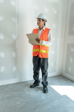 inspector or engineer is inspecting construction and quality assurance new house using a checklist. Engineers or architects or contactor work to build the house before handing it over to the homeowner