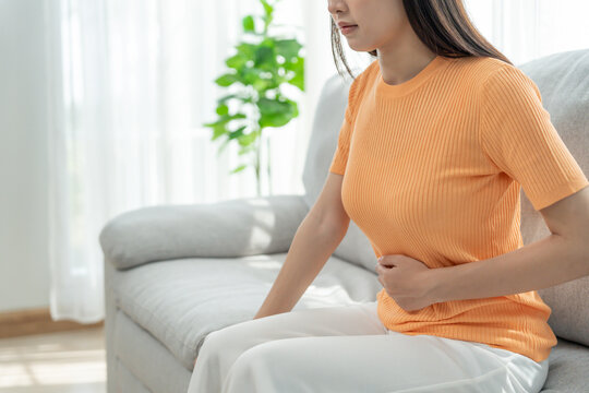 stomach ache. Asian women have abdominal pain, indigestion, gastritis, menstrual cramps, flatulence, diarrhea, distention, colon cancer, belly inflammation problem, suffer food poisoning, abdomen