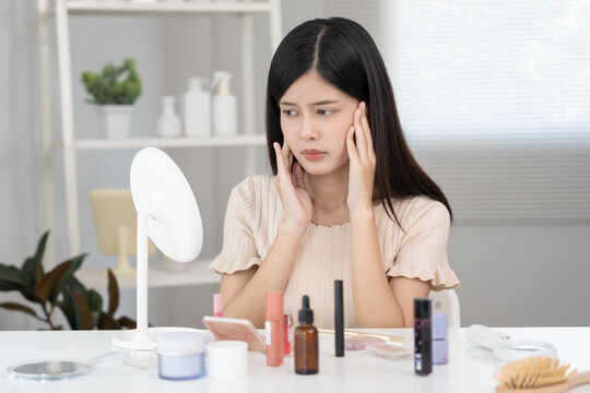 Young woman asian are worried about faces Dermatology and allergic to steroids in cosmetics. sensitive skin, red face from sunburn, acne, allergic to chemicals, rash on face. skin problems and beauty