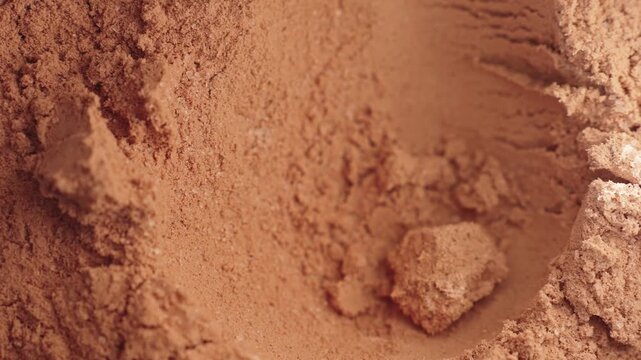 Close Up Chocolate Whey Protein Powder In Scoop, Slow Motion. Daily Fitness Nutrition And Supplement Preparation Routine