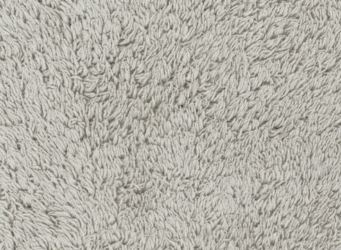Terry yarn closeup: long gray loops cluster above tiny recessed shadows in a soft pile texture for digital collage and scrapbook cover backgrounds requiring a pronounced fabric surface