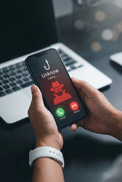 Person holding smartphone displaying unknown caller warning alert with red exclamation marks