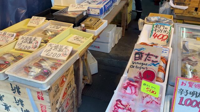 Fresh seafood market display with packaged octopus and fish in japan.