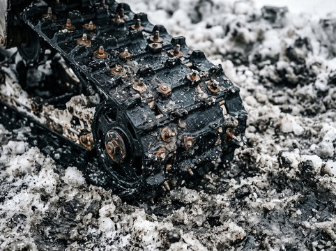 snowmobile track with metal spikes and mechanism details in close-up in the snow