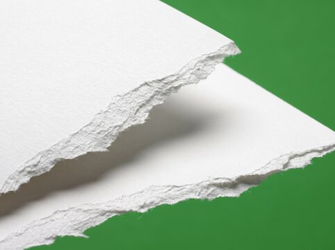 Ripped white paper sheets against a vibrant green background