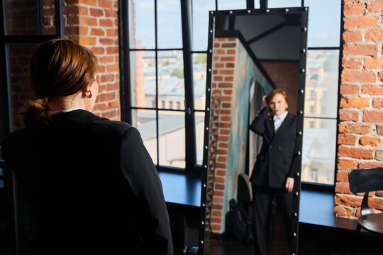 Poised individual stands assertively against urban background