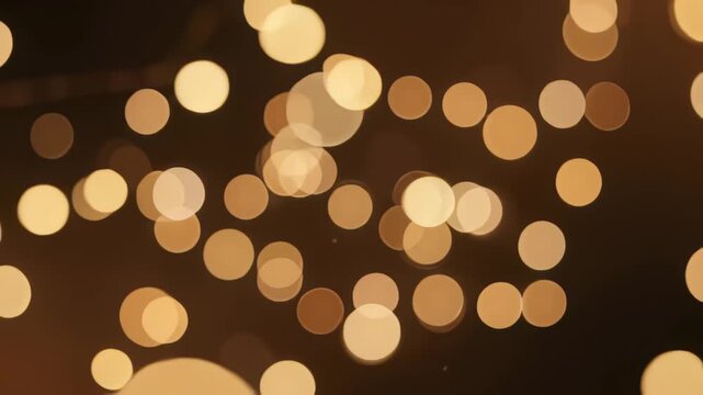 Golden bokeh background with blurred glowing lights and soft festive circles for design