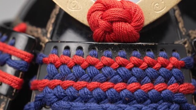 Japanese samurai helmet detail with braided cords and ornamental metal crest