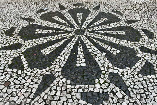 Close-up of design on traditional Portuguese mosaic pavement in downtown Curitiba, Brazil