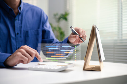 A professional holds a pen beside a calendar and digital task chart. A Gantt chart overlay, notebook and calculator illustrate project scheduling, workflow management and progress tracking at a desk.