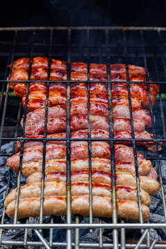 Traditional pork sausages cooking on a charcoal barbecue grill, Bourgogne-Franche-Comte, Dijon, France