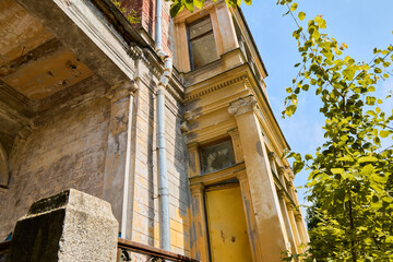 Corner view emphasizes decayed architecture touched by warm sunlight © diczman