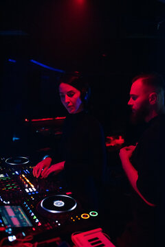 DJ Performs at Club With Red and Blue Lights During Night Event