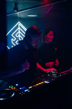 DJ Performs With Light Effects in a Nightclub Setting at Night