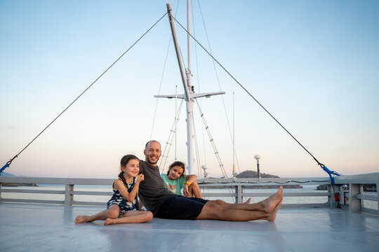 Family Enjoying Sunset on Boat Deck. Travel