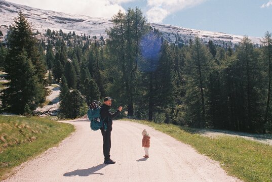 Father hiking with little child in the mountains