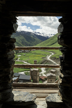 Mountain landscape framed by ancient tower window in Ushguli