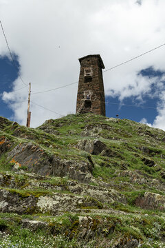 Medieval stone watchtower on hillside in Ushguli