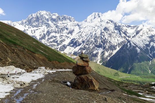Stone Cairn with Mount Shkhara in the Greater Caucasus, Georgia