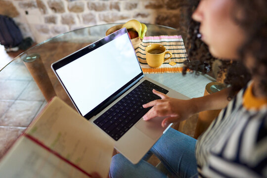 Woman working online at home using laptop