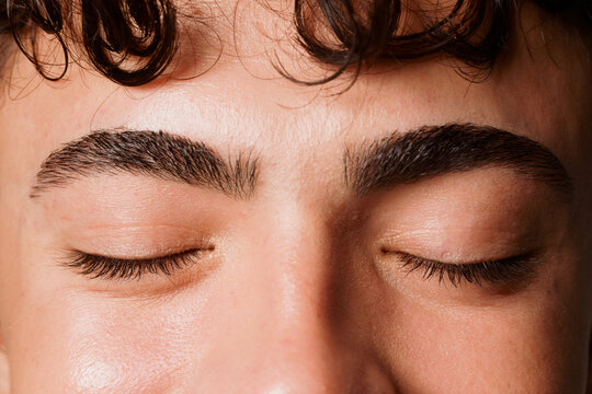 Young Person With Closed Eyes and Styled Eyebrows During a Photo Shoot