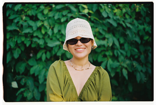 Portrait of Smiling Woman Wearing Bucket Hat Outdoors