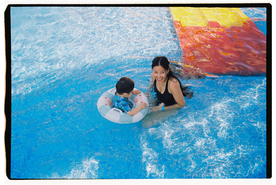 Mother and Toddler Enjoying Time Together in Swimming Pool