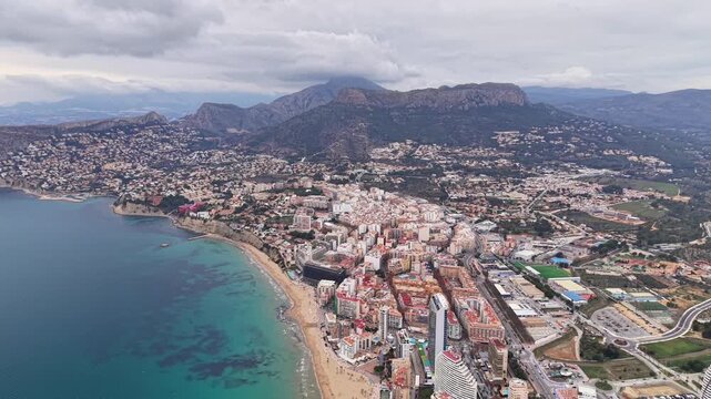 Coastal City Aerial Over Turquoise Sea, Dramatic Drone Sweep Showcasing Beachfront Hotels, Sandy Promenade,