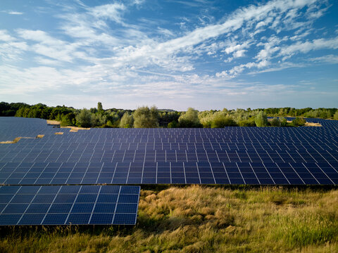 Solar Panels Cover a Large Field Under a Bright Sky