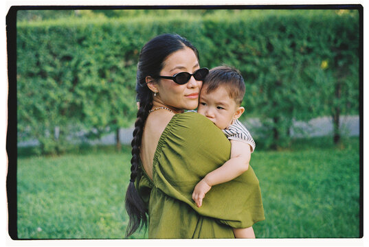 Portrait of Mother Holding Toddler Outdoors