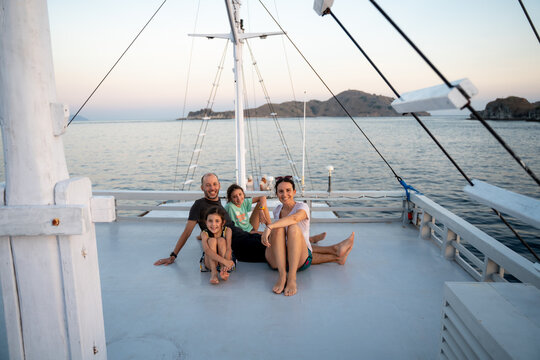 Family Enjoying Sunset on Boat Deck. Travel