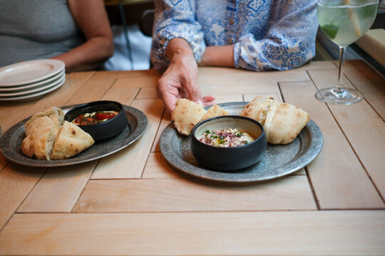 Woman enjoying falafel and hummus at restaurant